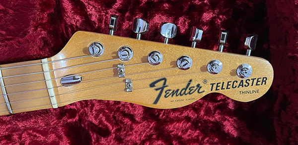 The headstock of the Walnut Striped Telecaster